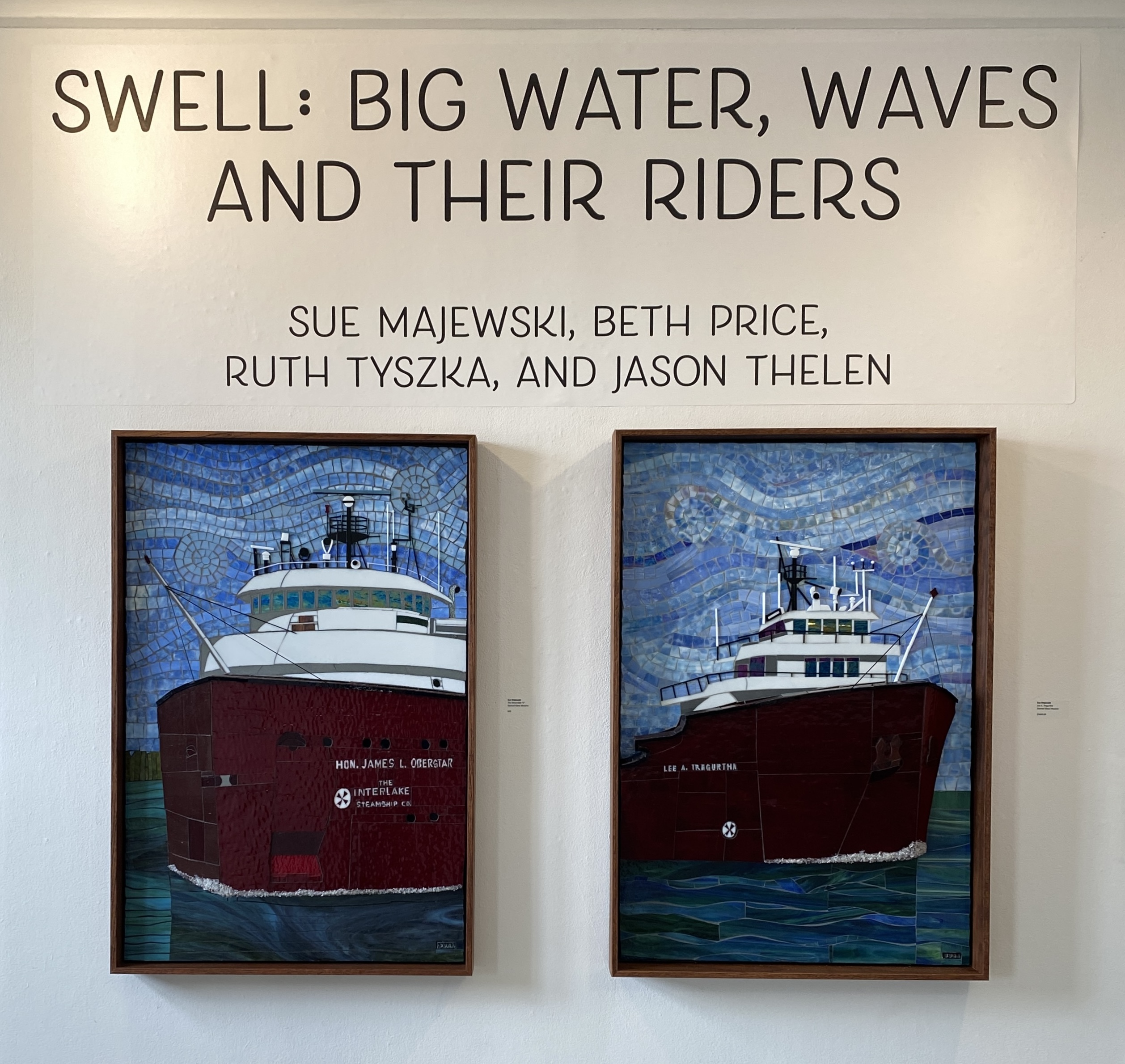 “SWELL: Big Water, Waves and Their Riders,” South Haven Center for the Arts 2025. Mosaic glass freighters by Sue Majewski.