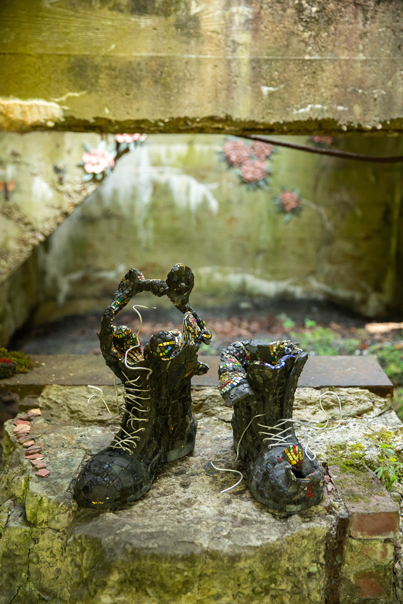 Helga Maribel Sanchez-Seda, "The Ruins Boots", 2023, Coal, shale, slate, red dog, taconite, Marcellus slate, malmischiato filati, smalti, gold smalti and copper. Installation Location: The Ruins, 549 River Road Perryopolis, Pennsylvania USA 2024 Best Site-Specific Mosaic